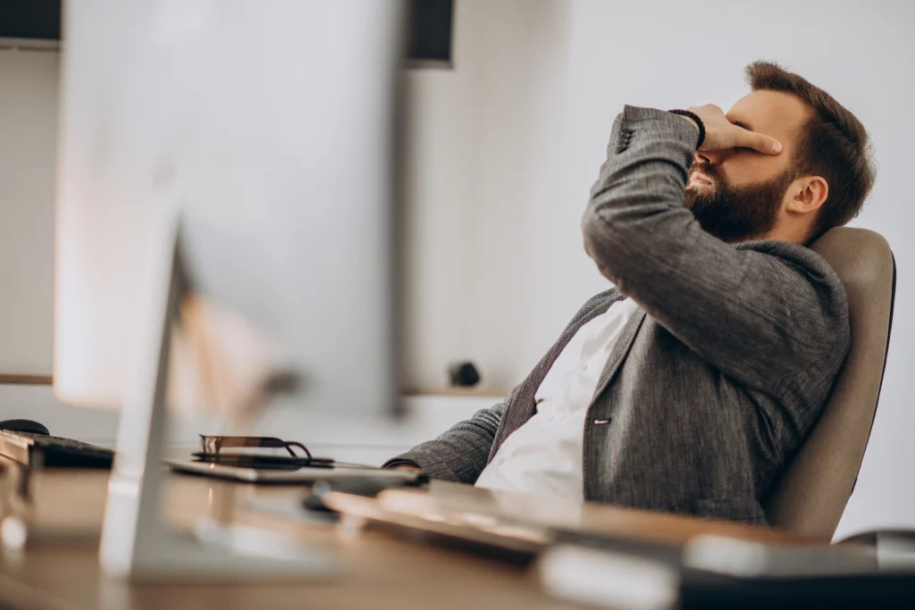 man experiencing burnout syndrome at work